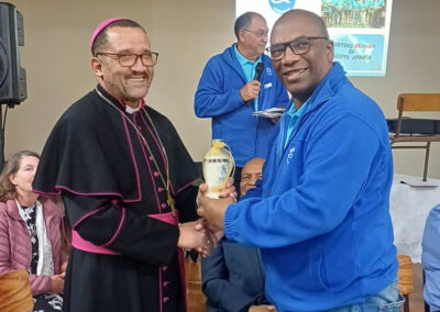 Archbishop Sithembele Sipuka receives a commemorative candle from Winston Fortuin, Cape Town Central president